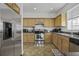 Well-lit kitchen featuring stainless steel appliances, ample counter space, and wood cabinets at 8957 N Red Maple Cir, Summerville, SC 29485