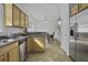 Functional kitchen with wood cabinetry, stainless steel appliances, and open access to the dining area at 8957 N Red Maple Cir, Summerville, SC 29485