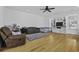 Bright living room featuring hardwood floors, ceiling fan and a built-in entertainment center with shelving at 8957 N Red Maple Cir, Summerville, SC 29485