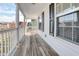 Charming front porch with white railings and a wooden floor at 8957 N Red Maple Cir, Summerville, SC 29485