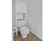 Bathroom toilet features a built-in shelving unit for storage and a neutral color palette at 8957 N Red Maple Cir, Summerville, SC 29485