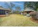 Backyard with lawn, screened in porch and a vintage car under a carport at 904 Randall Dr, Mount Pleasant, SC 29464