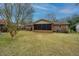 Backyard with lawn, exterior brick of house, screened in porch, tree and fence at 904 Randall Dr, Mount Pleasant, SC 29464