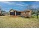 Backyard with lawn, exterior brick of house, screened in porch and a fence at 904 Randall Dr, Mount Pleasant, SC 29464