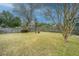 Large backyard with a wooden fence, mature trees, and well-maintained lawn at 904 Randall Dr, Mount Pleasant, SC 29464