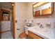 Bright bathroom featuring a vanity with sink and mirror, a wooden toilet seat and a walk-in shower at 904 Randall Dr, Mount Pleasant, SC 29464