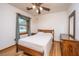 Bedroom with hardwood floors, ceiling fan, window with curtain and wood furniture at 904 Randall Dr, Mount Pleasant, SC 29464
