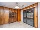 Cozy dining area with wood-paneled walls, linoleum floor, and sliding glass door at 904 Randall Dr, Mount Pleasant, SC 29464