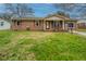 Charming brick home with a well-manicured front yard and inviting front porch at 904 Randall Dr, Mount Pleasant, SC 29464