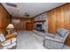 Cozy living room features brick fireplace, wood paneling, and carpeted flooring at 904 Randall Dr, Mount Pleasant, SC 29464