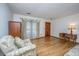 Bright living room showcasing hardwood floors, a wooden door, and bright natural light at 904 Randall Dr, Mount Pleasant, SC 29464