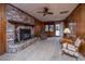 Spacious living room with a brick fireplace, wood paneling, and carpeted floor at 904 Randall Dr, Mount Pleasant, SC 29464