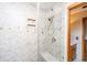 Updated shower featuring a tiled surround, glass door, and built-in seat at 904 Randall Dr, Mount Pleasant, SC 29464