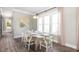 Cozy dining area with large windows, chandelier, and a rustic table set for a delightful meal at 966 Carnes Xing, Summerville, SC 29486