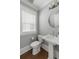 Clean half-bath with pedestal sink, toilet, and large window for natural light at 972 Key Colony Ct, Mount Pleasant, SC 29464