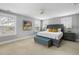 Spacious main bedroom with neutral carpet, a gray bed, a bench, and two bedside tables with lamps at 972 Key Colony Ct, Mount Pleasant, SC 29464