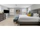 Well-appointed main bedroom featuring a gray bed, a tufted bench, a television, and bright natural light at 972 Key Colony Ct, Mount Pleasant, SC 29464