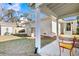 A fenced backyard with a patio, showing the home's exterior brick, and a small shed at 102 Live Oak Dr, Mount Pleasant, SC 29464