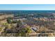 Aerial view of homes in a rural area with dense surrounding forest and fields on a bright sunny day at 1026 Cane Gully Rd, Moncks Corner, SC 29461