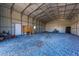 Spacious barn interior with gravel floor, metal walls, a riding lawn mower and ample storage space at 1026 Cane Gully Rd, Moncks Corner, SC 29461