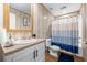 Cozy bathroom with a shower-tub combo, framed mirror, and decorative accents at 1026 Cane Gully Rd, Moncks Corner, SC 29461