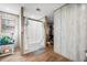 Well-lit bathroom features a shower with a curtain and adjacent closet for storage at 1026 Cane Gully Rd, Moncks Corner, SC 29461
