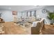 Well-decorated living room with hardwood floors, neutral sofa and armchairs, and plenty of natural light at 1026 Cane Gully Rd, Moncks Corner, SC 29461