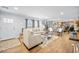 Bright and inviting living room featuring hardwood floors, neutral furniture, and an open layout into the kitchen at 1026 Cane Gully Rd, Moncks Corner, SC 29461
