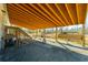 Outdoor living space underneath a raised house with wooden support beams and a bench and hammock at 1026 Cane Gully Rd, Moncks Corner, SC 29461