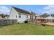 The beautiful white home exterior has a lush backyard and wood deck at 103 Hazelton Ct, Goose Creek, SC 29445