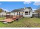 Charming home featuring a wood deck, lush green backyard, white siding and exterior door at 103 Hazelton Ct, Goose Creek, SC 29445
