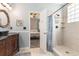 Bright bathroom with updated vanity, tile shower, and doorway to the bedroom at 103 Hazelton Ct, Goose Creek, SC 29445