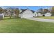 View of the home's exterior, showcasing the garage, yard, and surrounding landscape at 103 Hazelton Ct, Goose Creek, SC 29445