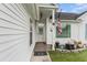 Inviting front porch with decorative plants, American flag, and ADT security system at 103 Hazelton Ct, Goose Creek, SC 29445