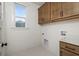 Clean laundry room featuring ample cabinet space and a well-lit window at 106 Abbey Terrace Rd, Moncks Corner, SC 29461