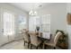 Bright dining room features a stylish light fixture and natural light from multiple windows at 109 Osprey Ridge Ln, Summerville, SC 29483