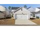 Exterior view of a single-car garage with white door and driveway, plus trees for shade at 109 Osprey Ridge Ln, Summerville, SC 29483