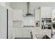 Close-up of a modern kitchen featuring white cabinets, stainless steel appliances, and a gas cooktop with an oven at 109 Osprey Ridge Ln, Summerville, SC 29483