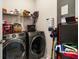Well-organized laundry room featuring modern washer and dryer, shelving, and storage solutions at 109 Osprey Ridge Ln, Summerville, SC 29483