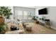 Comfortable living room with a sectional couch, decorative rug, and ample natural light from the many windows at 109 Osprey Ridge Ln, Summerville, SC 29483