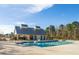 Community pool featuring a modern pool house with a metal roof and a bright blue sky at 109 Osprey Ridge Ln, Summerville, SC 29483