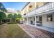 Backyard boasts a brick walkway, manicured landscaping, a grill, and covered patio with seating at 11 Church St, Charleston, SC 29401