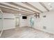 Finished basement offers wood-look flooring, and a rustic wood beam ceiling at 11 Church St, Charleston, SC 29401