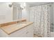 Bright bathroom boasts a sink with vanity, patterned shower curtain, and neutral color palette at 11 Church St, Charleston, SC 29401