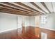 A spacious bedroom featuring exposed beams, hardwood floors and ensuite bathroom at 11 Church St, Charleston, SC 29401