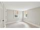 Comfortable bedroom with tile flooring, two windows offering natural light, and neutral paint at 11 Church St, Charleston, SC 29401