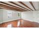 A naturally lit bedroom featuring exposed beams, hardwood floors, and multiple windows at 11 Church St, Charleston, SC 29401