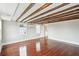 A spacious bedroom featuring exposed wood beams and hardwood floors at 11 Church St, Charleston, SC 29401
