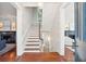 A foyer and staircase with hardwood floors and views of the living spaces at 11 Church St, Charleston, SC 29401