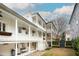 Multi-level exterior shows white columns, balconies with hanging baskets, and a well-maintained lawn at 11 Church St, Charleston, SC 29401